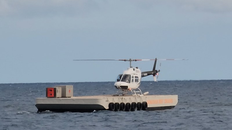 Helicopter on the helipad beside the Sunlover pontoon on Moore Reef