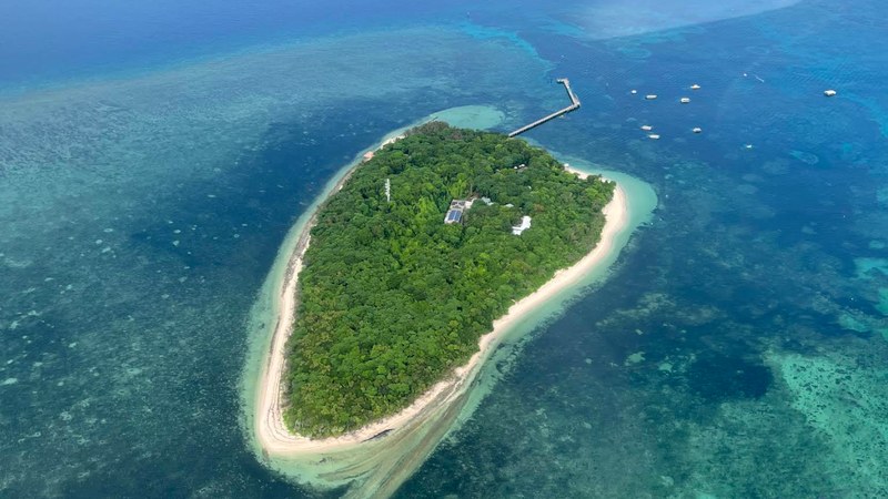 Green Island from the air — a coral cay with a white beach and jetty on the Great Barrier Reef