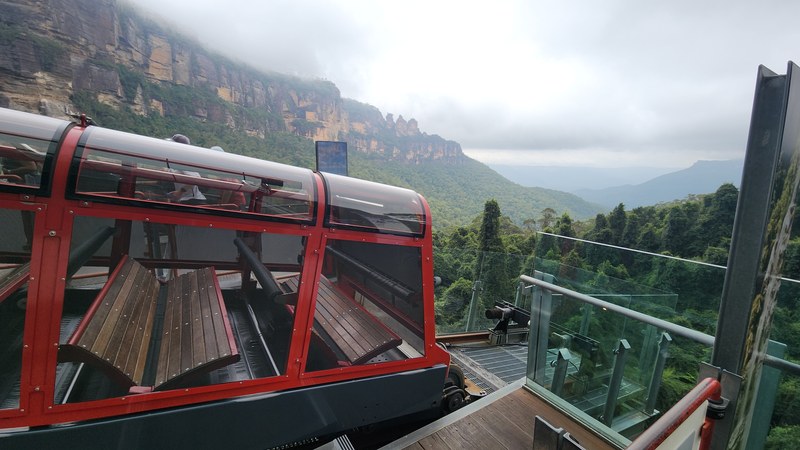 Scenic Railway carriage at Katoomba with the Three Sisters and Jamison Valley behind