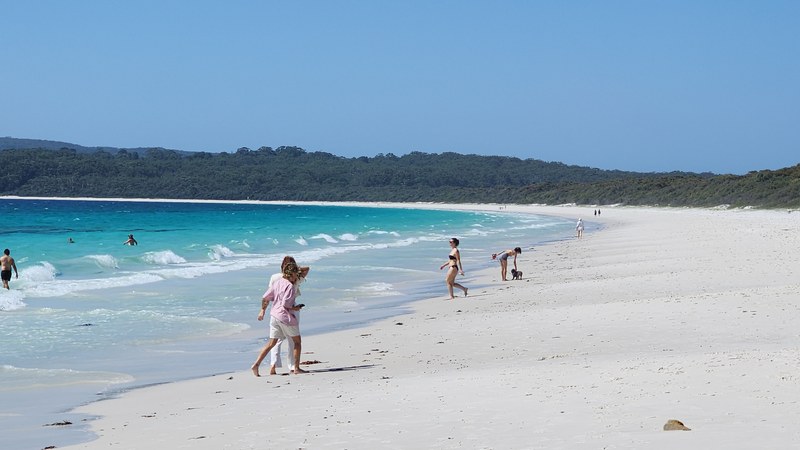 Hyams Beach in Jervis Bay — white sand and turquoise water with a few walkers